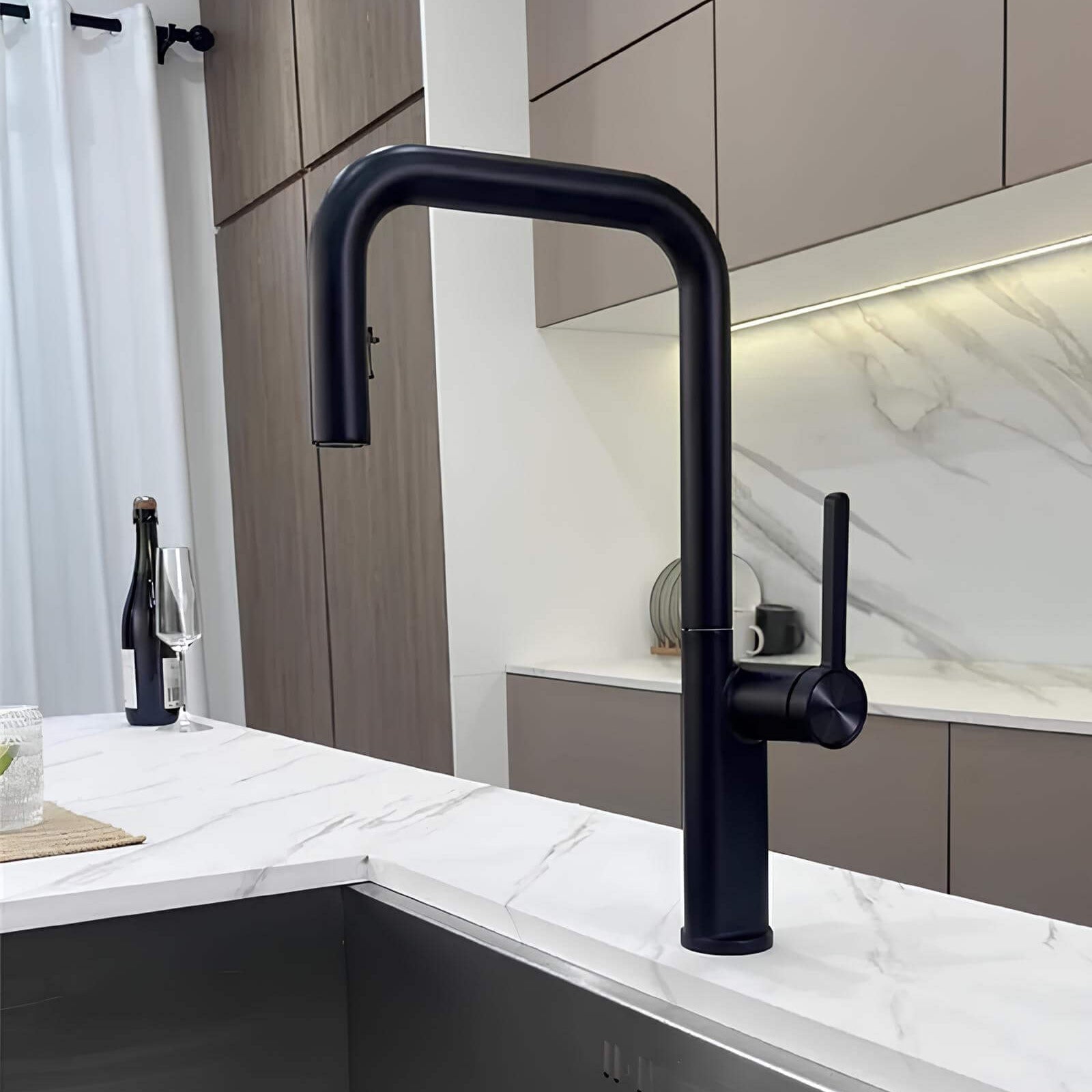 Designer brass kitchen faucet with pull-down sprayer and rotating spout